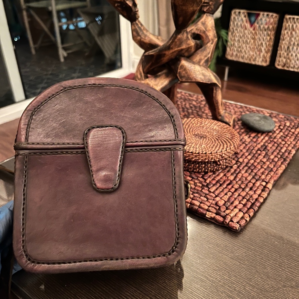 Box purse made of leather with Ankara fabric lining.
